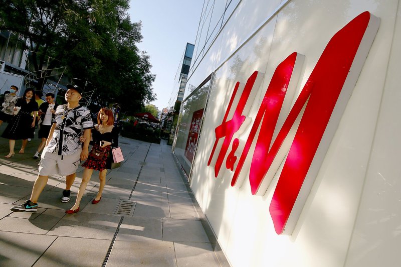 Chinese shoppers walk past a H&amp;M clothing store at a popular, international fashion gallery in Beijing, China, on July 5. The national statistics bureau reported Thursday that the economy grew 7.9% in the second quarter of the year, boosted by retail sales. Photo by Stephen Shaver/UPI