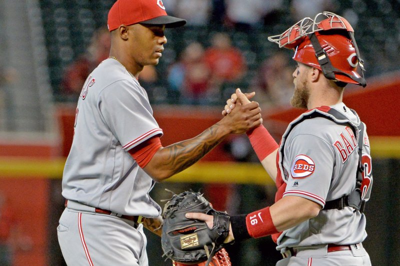 Cincinnati Reds' pitcher Raisel Iglesias (L) shakes hands with catcher Tucker Barnhart after the Reds defeated the Arizona Diamondbacks 7-4 on May 30 at Chase Field in Phoenix. Photo by Art Foxall/UPI