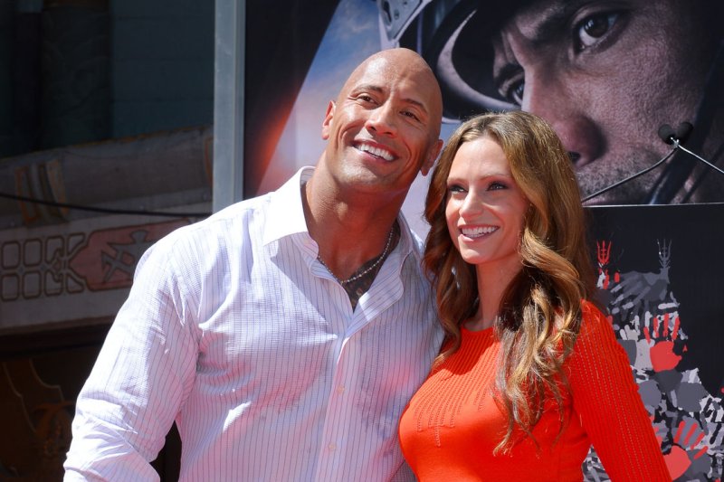 Actor Dwayne "The Rock" Johnson poses with his girlfriend, singer Lauren Hashian during a hand and footprint ceremony in May. Johnson has shared the first photo and name of his newborn daughter on social media. File Photo by Jim Ruymen/UPI