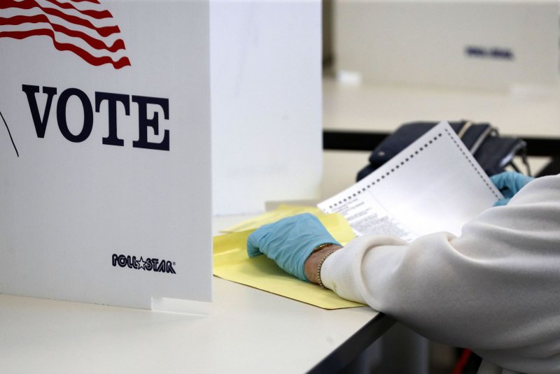 A voter wears gloves to guard against the coronavirus disease during the Ohio primary election on April 28. Judges in Manhattan on Tuesday ruled that New York must stage its primary in June. Photo by Aaron Josefczyk/UPI