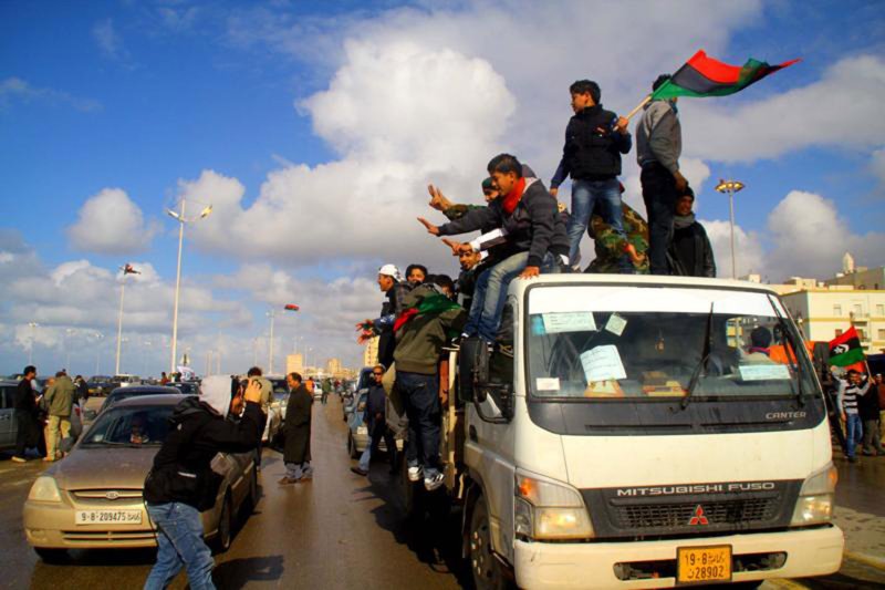 Libyans wave the old Libyan flag in the eastern dissident-held city of Benghazi on February 26, 2011. U.S. President Barack Obama urged Libyan leader Moammar Gadhafi to leave power immediately since he has lost his "legitimacy to rule." UPI\Mohamad Shaikhi