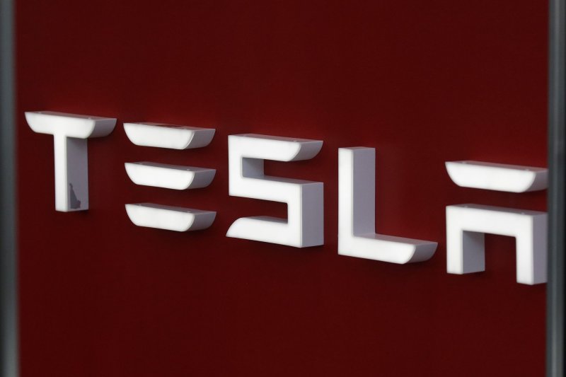 A Tesla sign hangs at the entrance to a Tesla dealership on Sept. 8. Tesla filed a lawsuit against the Trump administration on Monday demanding a refund on tariffs it has paid on Chinese products. Photo by John Angelillo/UPI | <a href="/News_Photos/lp/882ad46b88b4066a8800d3934dad5e58/" target="_blank">License Photo</a>