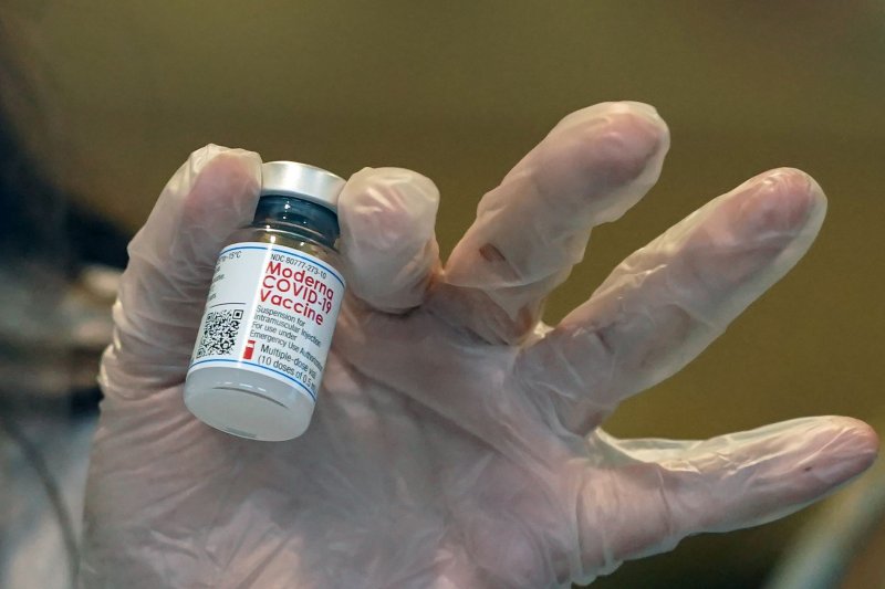 A pharmacist holds a vial of the Moderna COVID-19 vaccine at the Cottages of Lake St. Louis Retirement Center in Lake St. Louis, Mo., on December 28, 2020. File Photo by Bill Greenblatt/UPI | <a href="/News_Photos/lp/f1e670ac9d5b02f8cd4581444e7c1750/" target="_blank">License Photo</a>
