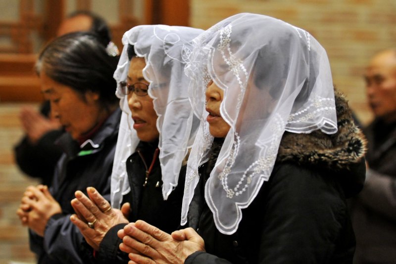 South Korean residents pray during Christmas mass on Yeonpyeong Island, South Korea in 2010. South Korean residents of the bombarded island are worried about another North Korea retaliation. File Photo by Keizo Mori/UPI