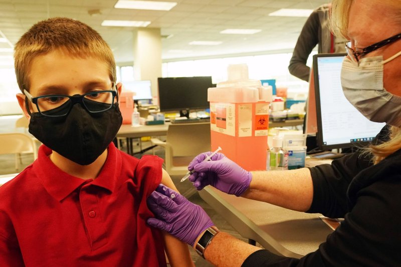 Brendan Goldsborough, 12, sits as nurse Kathy Farrar injects vaccine into his arm at Mercy's COVID Vaccine Clinics in Kirkwood, Mo., on May 13. An FDA committee has recommended that children 5-11 should receive the Pfizer vaccine. File Photo by Bill Greenblatt/UPI