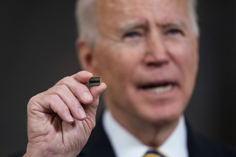 President Joe Biden, who's holding up a semiconductor chip in this February 24, 2021, photo, praised the Senate vote. File Photo by Doug Mills/UPI