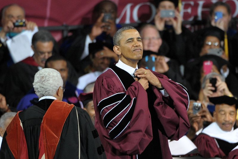 President Barack Obama pretends to straighten up before he receives an honorary degree after delivering the commencement address to more 500 graduating students at Morehouse College in Atlanta on May 19, 2013. File Photo by David Tulis/UPI