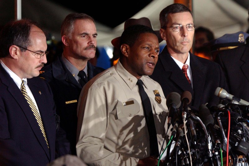 Montgomery County police Chief Charles Moose and other law enforcement officials announce the capture of two suspects in the sniper shootings during a press conference on October 24, 2002, in Rockville, Md. Moose died Thursday. File Photo by Roger L. Wollenberg UPI