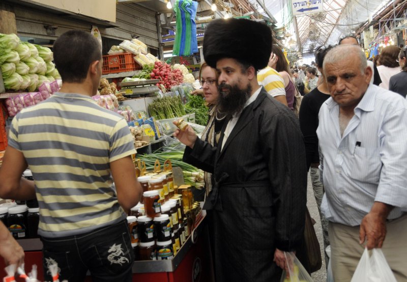 An Ultra-Orthodox Jew, wearing a shtreimel, buys honey on the eve of Rosh HaShanah, (UPI Photo/Debbie Hill)