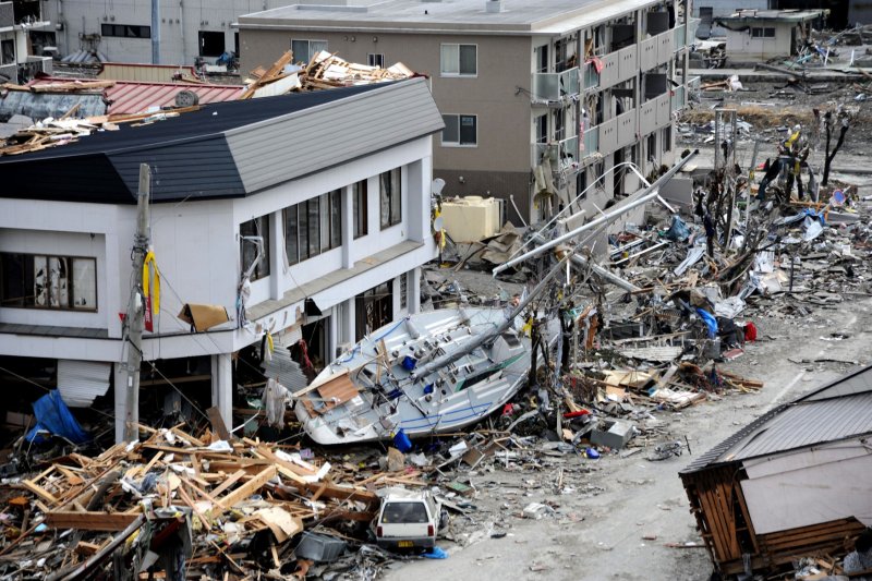A fishing boat is seen on a street in Ofunato, Japan after being swept ashore during a massive tsunami that impacted the Japanese fishing port town. Ofunato was devastated by an 8.9-magnitude earthquake that triggered the destructive tsunami, which ravaged Japan's eastern seaboard. Teams from the United States, United Kingdom and China arrived here to assist in searching for missing residents. UPI/U.S. Navy Photo