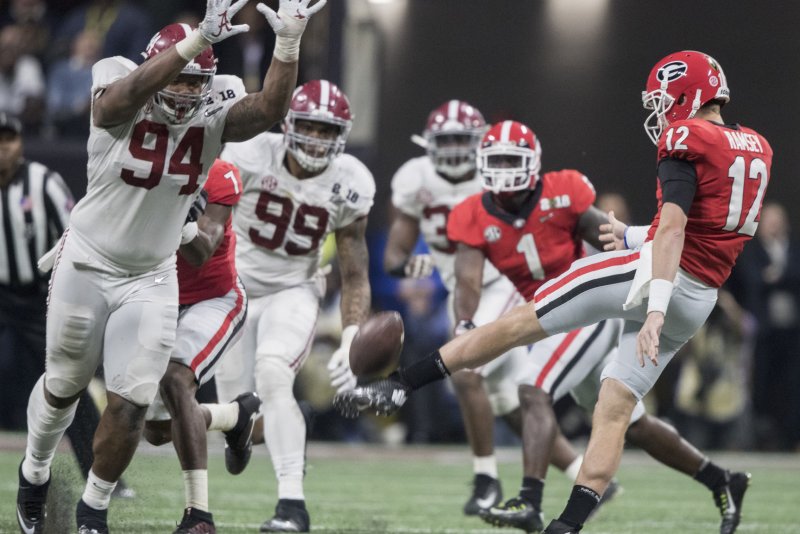 Former Alabama Crimson Tide defensive lineman Da'Ron Payne (94) attempts to block the punt of Georgia Bulldog's Brice Ramsey (12) in the fourth quarter of the NCAA College Football Playoff National Championship on January 8 at Mercedes-Benz Stadium in Atlanta. Photo by Mark Wallheiser/UPI