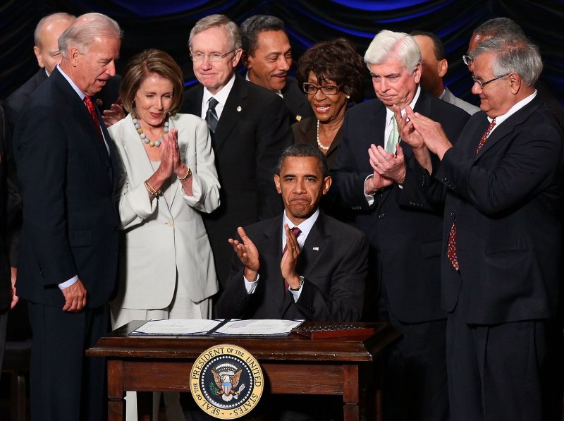 U.S. President Barack Obama signs the Dodd-Frank Wall Street Reform and Consumer Protection Act before (L-R) Vice President Joe Biden, Speaker of the House Nancy Pelosi (D-CA), Senate Majority Leader Harry Reid (D-NV), Rep. Maxine Waters (D-CA), Sen. Chris Dodd (D-CT) and Rep. Barney Frank (D-MA) at the Ronald Reagan Building July 21, 2010 in Washington, DC. The bill is the strongest financial reform legislation since the Great Depression and also creates a consumer protection bureau that oversees banks on mortgage lending and credit card practices UPI/Win McNamee/Pool