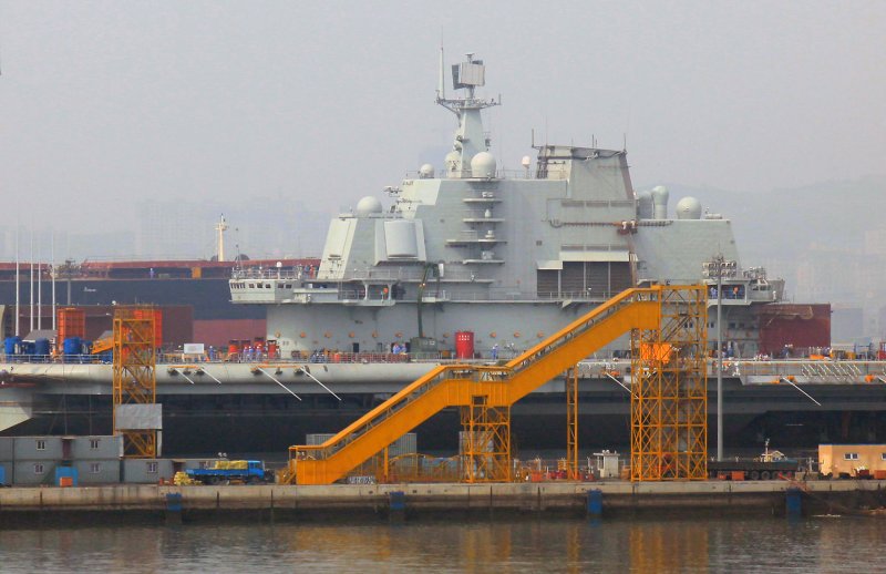 China's new Russian-built aircraft carrier sits in dry dock, after completing a series of sea trials earlier in the month, in the country's northeast port city Dalian on August 29, 2011. The carrier, a retrofitted ship called the Varyag, has long been seen as the first step in China's plan to eventually build a handful of carriers as part of a wider strategy to develop its naval might. UPI/Stephen Shaver | <a href="/News_Photos/lp/26c9243983384966b0b2901f401a1ccc/" target="_blank">License Photo</a>
