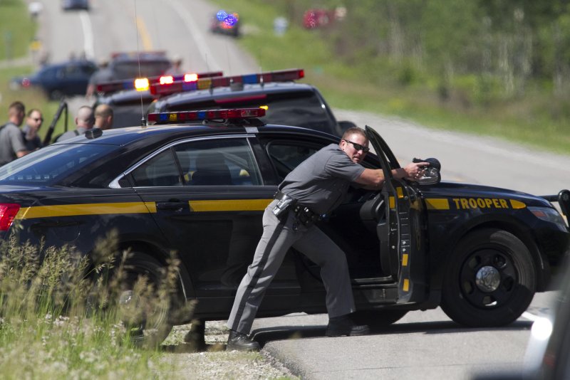 Law enforcement personnel stand at the scene along Route 30 near the Elephant Head trail in Malone, New York where escaped prisoner Richard Matt is believed to have been shot dead on June 26, 2015. Law enforcement were called to Route 30 by a 911 call from a motorist who heard shots fired. A second prisoner David Sweat is still on the loose. Photo by Matthew Healey/UPI | <a href="/News_Photos/lp/01dee9ff67463ef4ed5843b8fc604cfb/" target="_blank">License Photo</a>