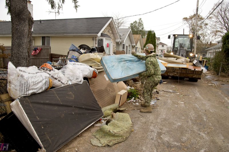 A Seabee assigned to Naval Mobile Construction Battalion from Gulfport, Mississippi, loads a bulldozer with debris that was caused by Hurricane Sandy during to relief efforts in Staten Island, New York, on November 7, 2012. The U.S. Navy has positioned forces in support of FEMA and local civil authorities following the destruction caused by Hurricane Sandy. UPI/ Martin Cuaron/Navy