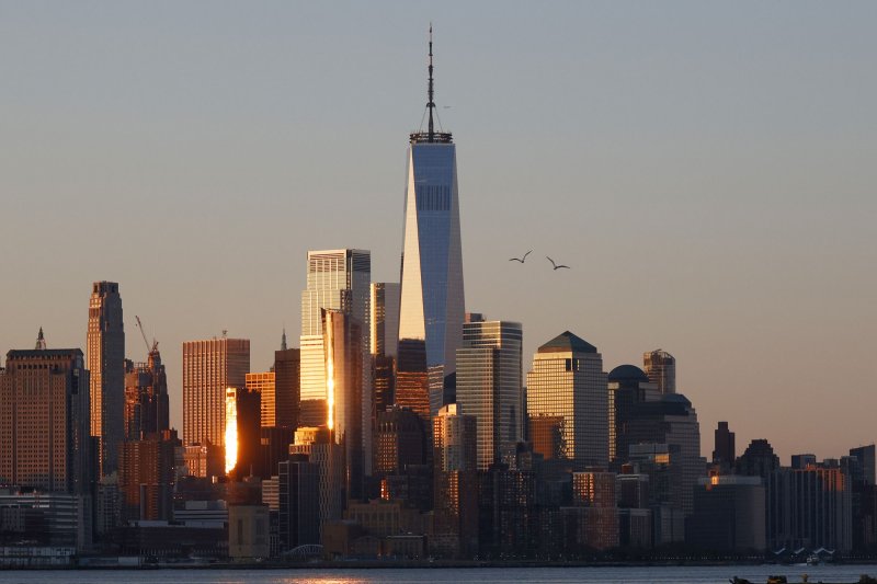 The sun rises and shines on One World Trade Center in Manhattan, New York City on April 23. About 80,000 municipal workers are being allowed to return to their work offices in the city on Monday. Photo by John Angelillo/UPI