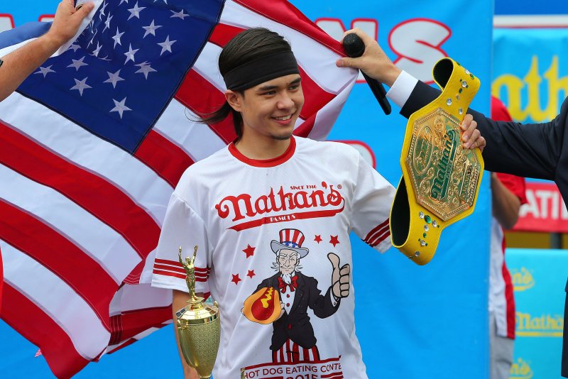 Matt Stonie celebrates after defeating Joey Chestnut at the Nathan's Famous Fourth of July International Hot Dog Eating Contest in Coney Island, NY on July 4, 2015. The Nathan's Famous Fourth of July International Hot Dog Eating Contest has occurred each July 4th in Coney Island since 1916. Matt Stonie won by eating 62 Hot Dogs in 10 minutes. Photo by Mike Stobe/UPI | <a href="/News_Photos/lp/706b4637b7281aedf08a0b97a6c9cc16/" target="_blank">License Photo</a>