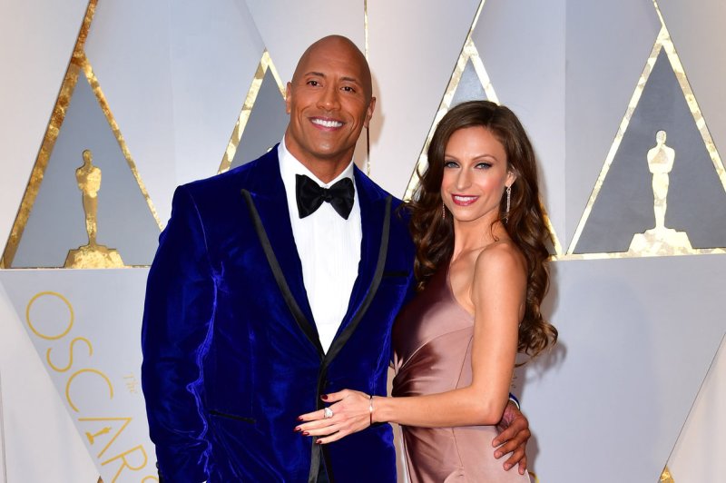 Dwayne Johnson (L) and Lauren Hashian arrive on the red carpet for the 89th annual Academy Awards on February 26. Johnson has commented on the upcoming "Fast and Furious" spinoff film on social media. File Photo by Kevin Dietsch/UPI