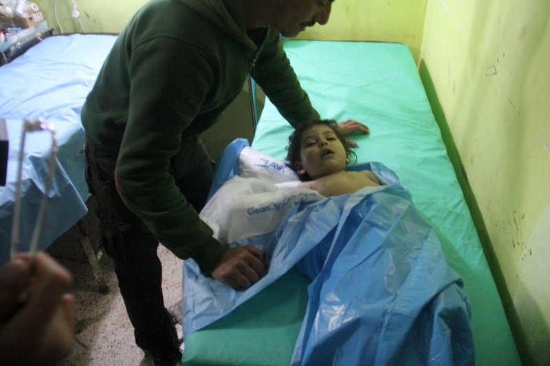 An unconscious Syrian child receives treatment at a hospital in Khan Sheikhun, a rebel-held town in the Syrian Idlib province, following a suspected toxic gas attack on April 4, 2017. File Photo by Omar Haj Kadour/UPI | <a href="/News_Photos/lp/c7745a87db6fc79dfe4f9e41c07ff285/" target="_blank">License Photo</a>