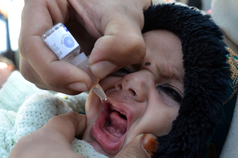 A health worker administers a polio vaccine to a child during a three day nationwide vaccination campaign to eradicate polio, in the civil hospital in the Pakistani border town, Chaman, along the Afghanistan border, January 20, 2014. UPI/Matiullah