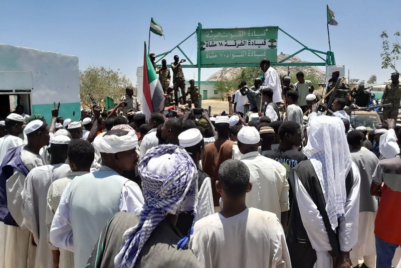 Sudanese people loyal to the national army attend a demonstration to support the army chief Abdel Fattah al-Burhan in Al Qadarif City, Sudan, on April 20. The army walked away from cease-fire negotiations on Wednesday. File Photo by Sudan News Agency