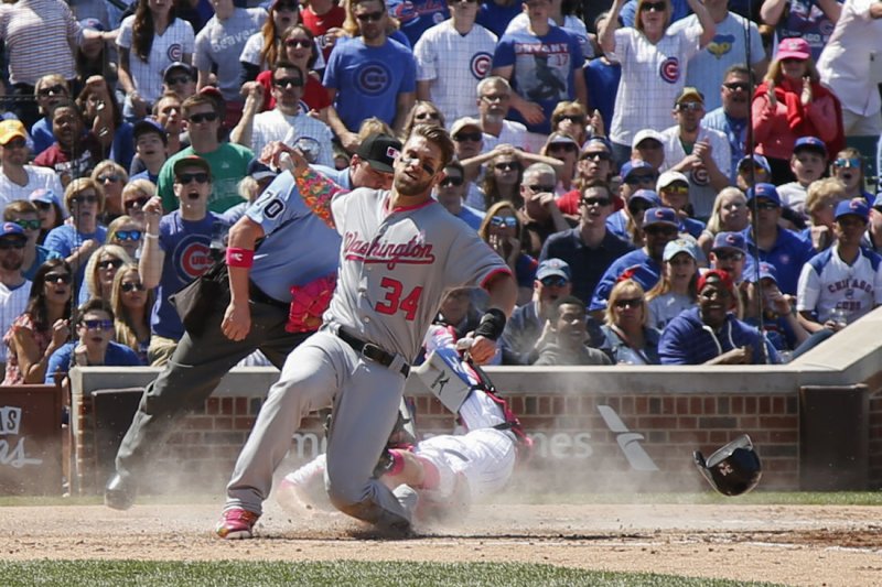 Washington Nationals right fielder Bryce Harper (34) scores as Chicago Cubs catcher Tim Federowicz (15) makes a late tag during the third inning at Wrigley Field in Chicago on May, 8, 2016. Photo by Kamil Krzaczynski/UPI