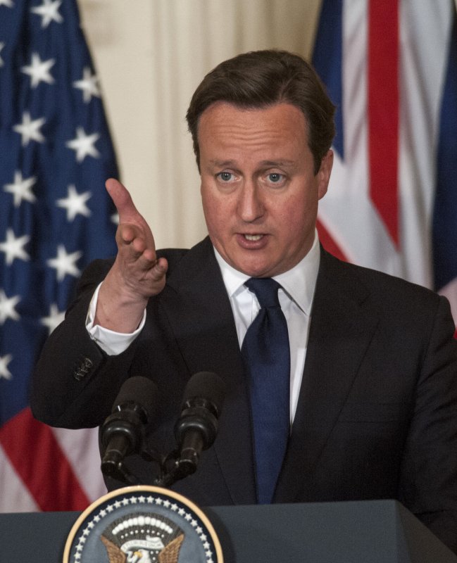 With American and British flags in the background, British Prime Minister David Cameron makes a comment as U.S. President Barack Obama (not shown) listens during a joint press conference in East Room of the White House in Washington, DC on May 13, 2013. The two world leaders discussed the Syria situation and other world and domestic issues. UPI/Pat Benic