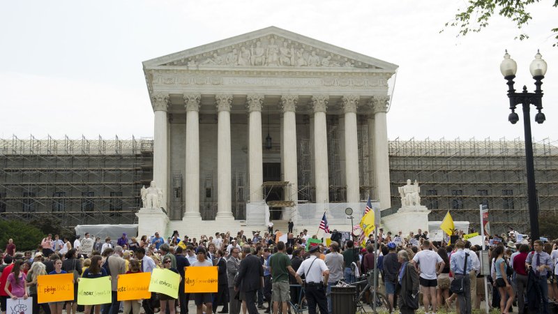 Protesters gather in front of the U.S. Supreme Court as they wait for the court's ruling on the Affordable Care Act on June 28, 2012 in Washington, D.C. The court upheld a majority of President Obama's healthcare reform bill, ruling in a 5-4 decision to keep the individual insurance mandate. UPI/Kevin Dietsch