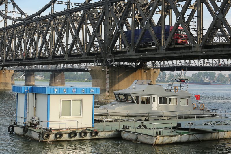 Trucks travel across the Yalu River on the Friendship Bridge to North Korea from Dandong, China's largest border city with North Korea. China has been working toward greater connectivity with cities along the North Korea border Photo by Stephen Shaver/UPI