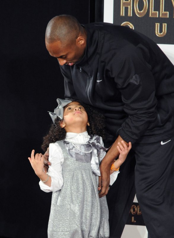 Los Angeles Lakers' Kobe Bryant hugs his daughter Gianna Bryant following a hand and footprint ceremony at Grauman's Chinese Theatre in Los Angeles on February 19, 2011. The two died January 26, 2020, in a helicopter crash. File Photo by Jim Ruymen/UPI