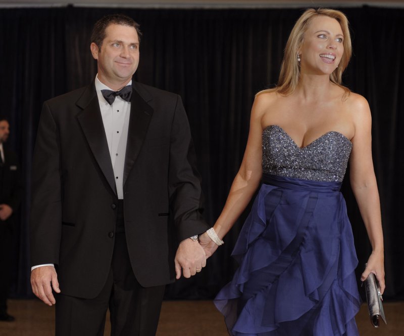 TV journalist Lara Logan, who was sexually assaulted while covering the unrest in Egypt, holds hands with her husband Joseph Burkett, as they pose for photographers on the red carpet as they arrive for the annual White House Correspondent's Association dinner, April 30, 2011, in Washington,D.C. President Obama will attend the dinner, which combines the administration's top officials, Capitol Hill politicians and Hollywood glitz and glamour. UPI/Mike Theiler