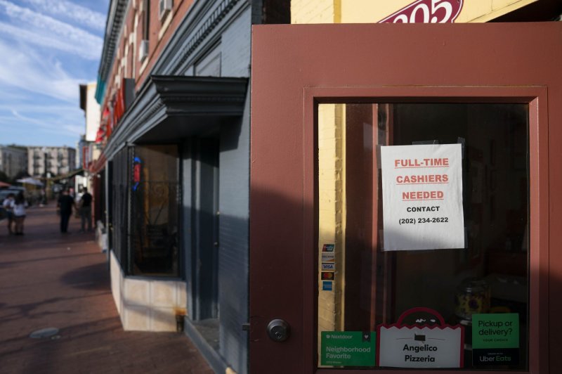 A sign seeking applications for new employees is seen in the window of Angelico Pizzeria in the Mount Pleasant neighborhood of Washington, D.C., on October 14. Photo by Sarah Silbiger/UPI