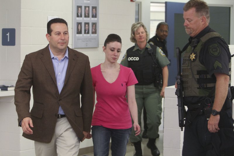 Casey Anthony (center) walks out of the the Orange County Jail with her attorney Jose Baez (left) after being released at 12:08 am July 17, 2011 in Orlando, Florida. Anthony was acquitted in the death of her daughter, Caylee. UPI/Red Huber/Pool