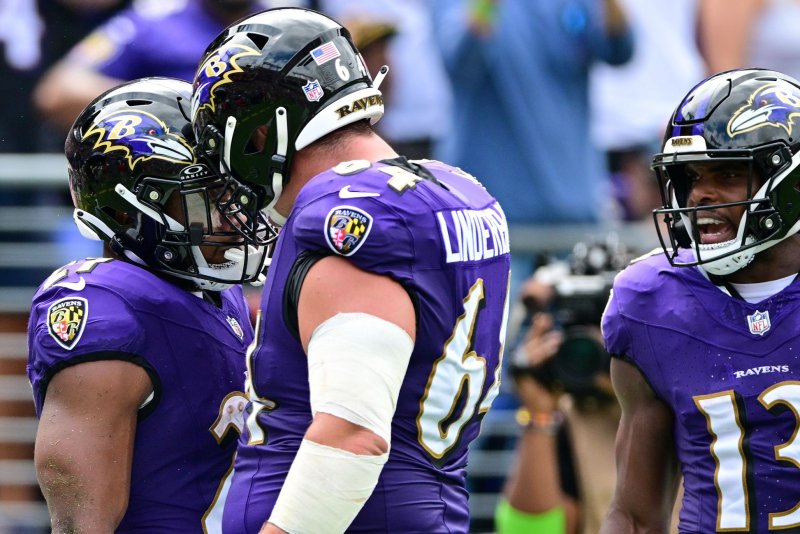 Baltimore Ravens running back J.K. Dobbins (L) reacts with center Tyler Linderbaum (C) after a touchdown against the Houston Texans on Sunday at M&amp;T Bank Stadium in Baltimore. Photo by David Tulis/UPI