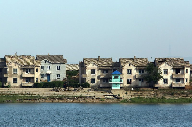 A North Korean guard tower, next to dilapidated houses, guards the border near the North Korean city of Sinuiju, across the Yalu River from Dandong, China. North Koreans caught for practicing religions not sanctioned by the state face imprisonment and even death, according to a South Korean NGO. Photo by Stephen Shaver/UPI | <a href="/News_Photos/lp/c29b6acf6ffce2a3004e081d23ded31e/" target="_blank">License Photo</a>