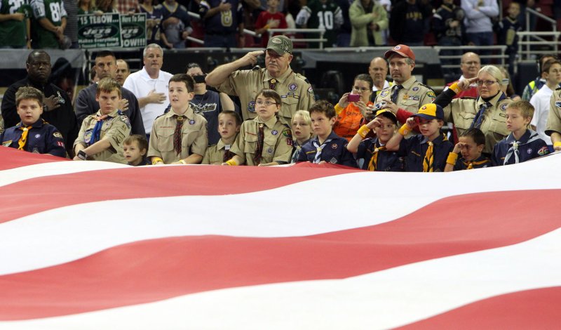 Cub Scouts and Boy Scouts hold an oversized American flag during ceremonies honoring veterans before the New York Jets-St. Louis Rams football game at the Edward Jones Dome in St. Louis on November 18, 2012. UPI/Bill Greenblatt | <a href="/News_Photos/lp/934fb1b898fd45b12eac8dc80272a617/" target="_blank">License Photo</a>