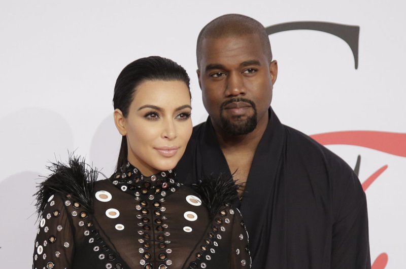 Kim Kardashian (L) and husband Kanye West at the CFDA Fashion Awards on June 1. The reality star responded to critics with a nude pregnancy photo Tuesday. File photo by John Angelillo/UPI