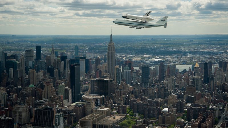 Space shuttle Enterprise, mounted atop a NASA 747 Shuttle Carrier Aircraft (SCA), is seen as it flies near the Empire State Building, April 27, 2012, in New York. Enterprise was the first shuttle orbiter built for NASA performing test flights in the atmosphere and was incapable of spaceflight. Originally housed at the Smithsonian's Steven F. Udvar-Hazy Center, Enterprise will be demated from the SCA and placed on a barge that will eventually be moved by tugboat up the Hudson River to the Intrepid Sea, Air & Space Museum in June. UPI/NASA/Robert Markowitz