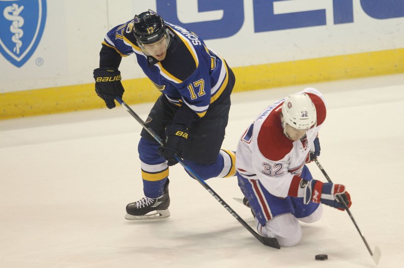 St. Louis Blues Jaden Schwartz and Montreal Canadiens Brian Flynn battle for possession of the puck in the first period at the Scottrade Center in St. Louis on December 6, 2016. St. Louis defeated Montreal 3-2 in overtime. Photo by Bill Greenblatt/UPI | <a href="/News_Photos/lp/2cc0c9f2cec4d903c33d17ea1d094d04/" target="_blank">License Photo</a>