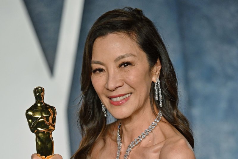 Michelle Yeoh holds up her Best Actress Oscar as she arrives for the Vanity Fair Oscar Party in Los Angeles on March 12, 2023. She will receive the Women In Motion Award from the Cannes Film Festival in May. Photo by Chris Chew/UPI