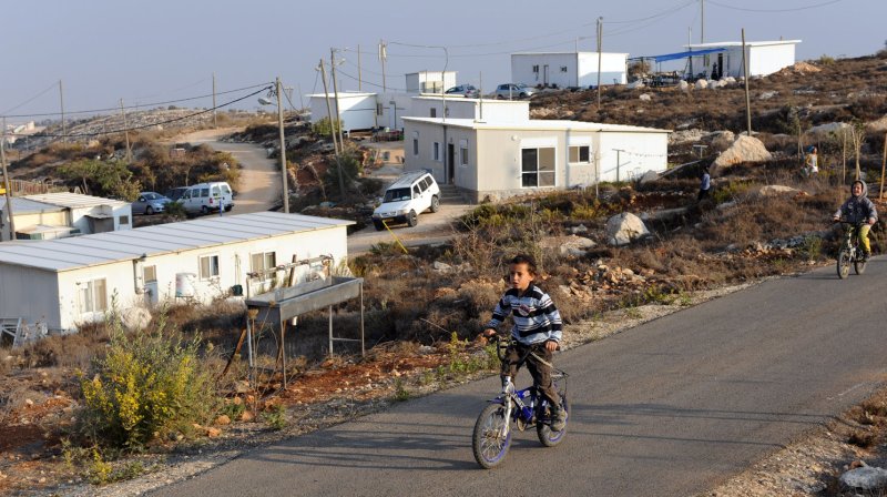 An Israeli settler boy rides a bike in the illegal Jewish settlement Givat Asaf in the West Bank near Ramallah, October 27, 2011. UPI/Debbie Hill