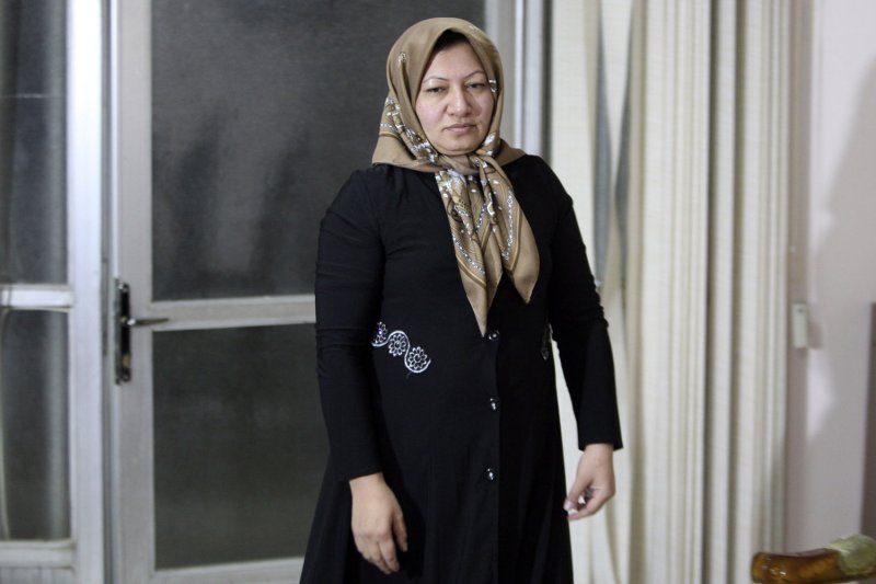 Sakineh Mohammadi Ashtiani, an Iranian woman convicted of murder and adultery, and sentenced to death by stoning, walks to a room to speak with media as she meets with her son, Sajjad Qaderzadeh (unseen), in the northwestern city of Tabriz, on January 1, 2011. After international outcry her sentence is being reconsidered by the Iranian judiciary. UPI Photo