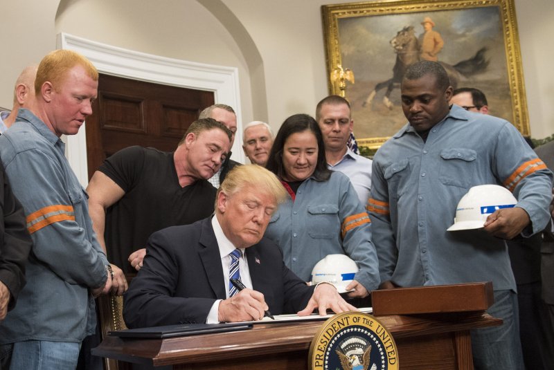 President Donald J. Trump signs a proclamation applying tariffs to steel and aluminum imports, as he is joined by steel and aluminum makers in the Roosevelt Room at the White House in Washington, D.C. on March 8, 2018. Photo by Kevin Dietsch/UPI