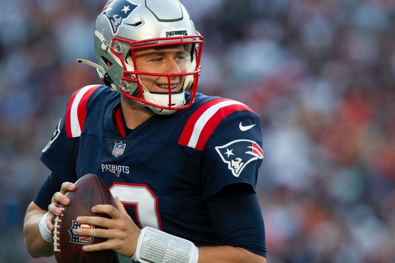 New England Patriots quarterback Mac Jones throws warm-up passes during a break in the second quarter against the Miami Dolphins on Sunday at Gillette Stadium in Foxborough, Mass. Photo by Matthew Healey/UPI