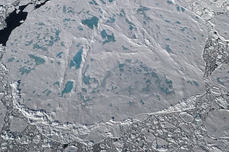 This NASA image taken on July 17, 2017, shows a large circular sea ice floe covered with melt ponds in northern Greenland showing the impact of ice melt due to climate change. A new study this week said The Greenland ice shoot is melting faster in the early 2000s. File Photo by Nathan Kurtz/NASA/UPI