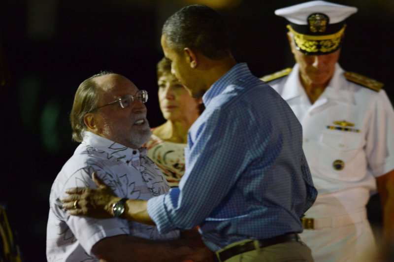 President Barack Obama greets Hawaii Governor Neil Abercrombie upon arrival with his family at Joint Base Pearl Harbor-Hickam in Peal Harbor, Hawaii to start their winter vacation on December 20, 2013. UPI/Cory Lum