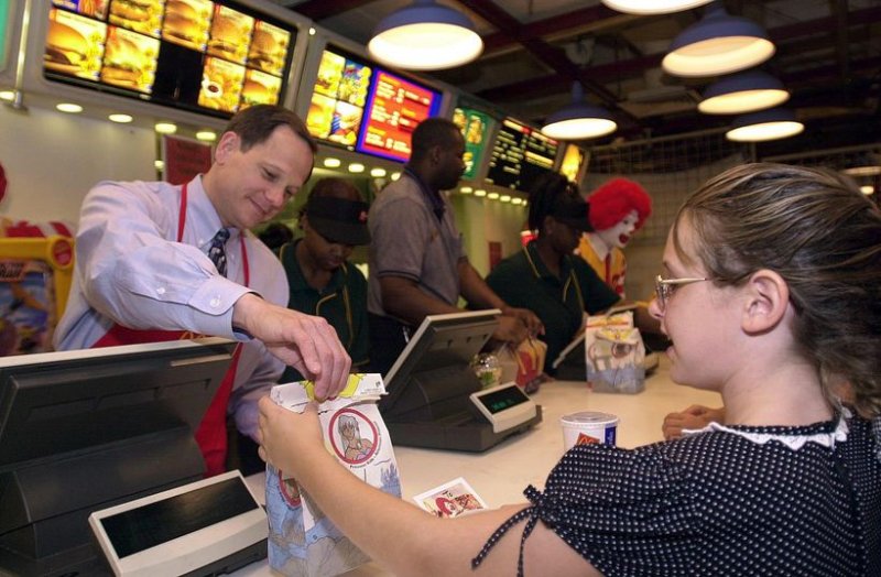 ST. LOUIS -- St. Louis Mayor Francis G. Slay, serves a happy meal to 10-year-old Paige Quirin, during his shift at the McDonald's in Union Station in St. Louis, Missouri, June 15, 2001. Slay worked the counter at McDonald's to help raise money and awareness for the United Negro College Fund (UNCF). bg/Bill Greenblatt UPI