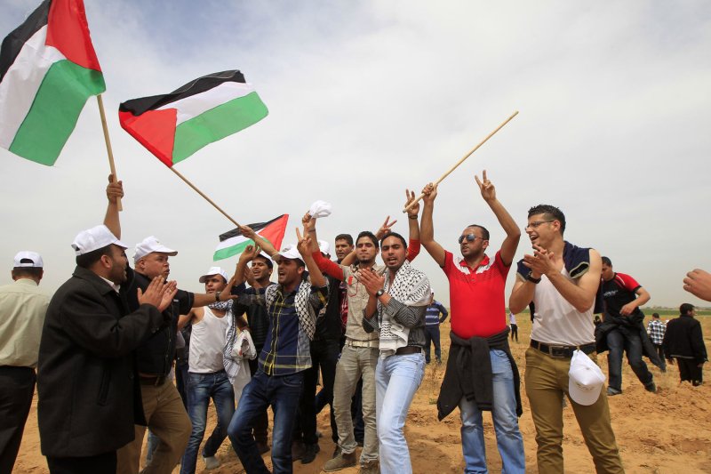Palestinian protesters shout slogans during a rally marking Land Day near the southern Gaza border with Israel, east of Rafah, on March 30, 2013. The Israeli army fired bullets in the air, to break up groups of Palestinians as annual Land Day rallies turned violent. Land Day commemorates the killing by security forces of six Arabs in 1976 during protests against government plans to confiscate land in northern Israel's Galilee region. UPI/Ismael Mohamad