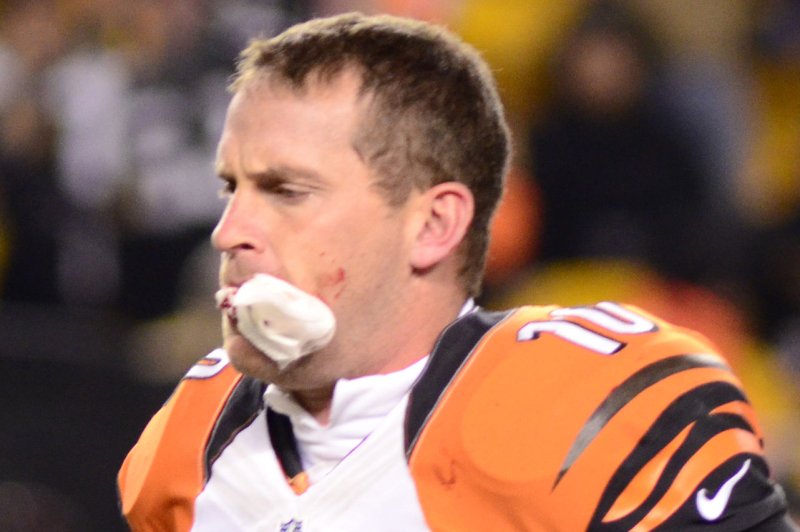 Cincinnati Bengals punter Kevin Huber (10) runs off the field with gauze in his mouth and blood on his cheek in the first quarter on December 15, 2013 at Heinz Field in Pittsburgh. (File/UPI/Archie Carpenter)