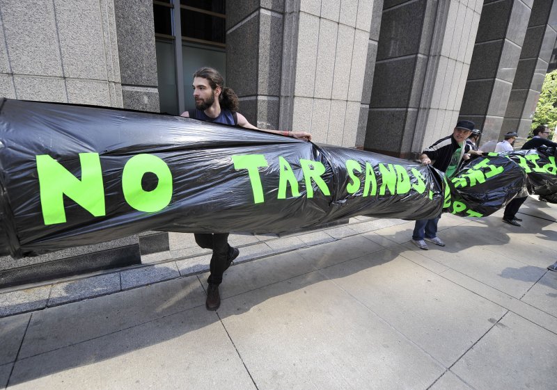 Protesters demonstrate outside of the Canadian consulate against Athabasca oil sands production and the Keystone Pipeline on May 17, 2012 in Chicago. UPI/Brian Kersey